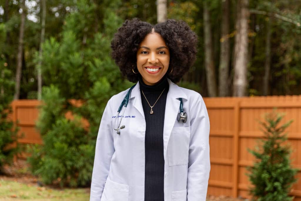 Dr. Marsha-gail Davis in her white coat smiling