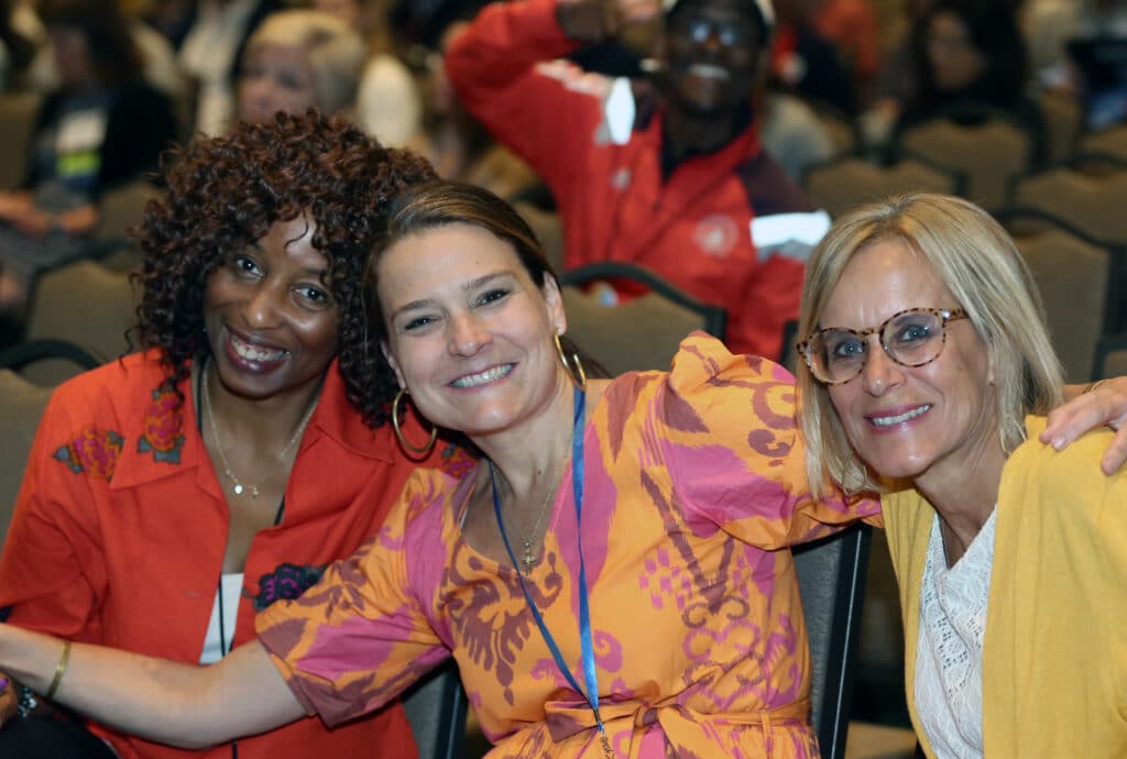 Three Happy Members In Bright Clothing