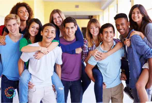 Image of a group of happy teenagers smiling.